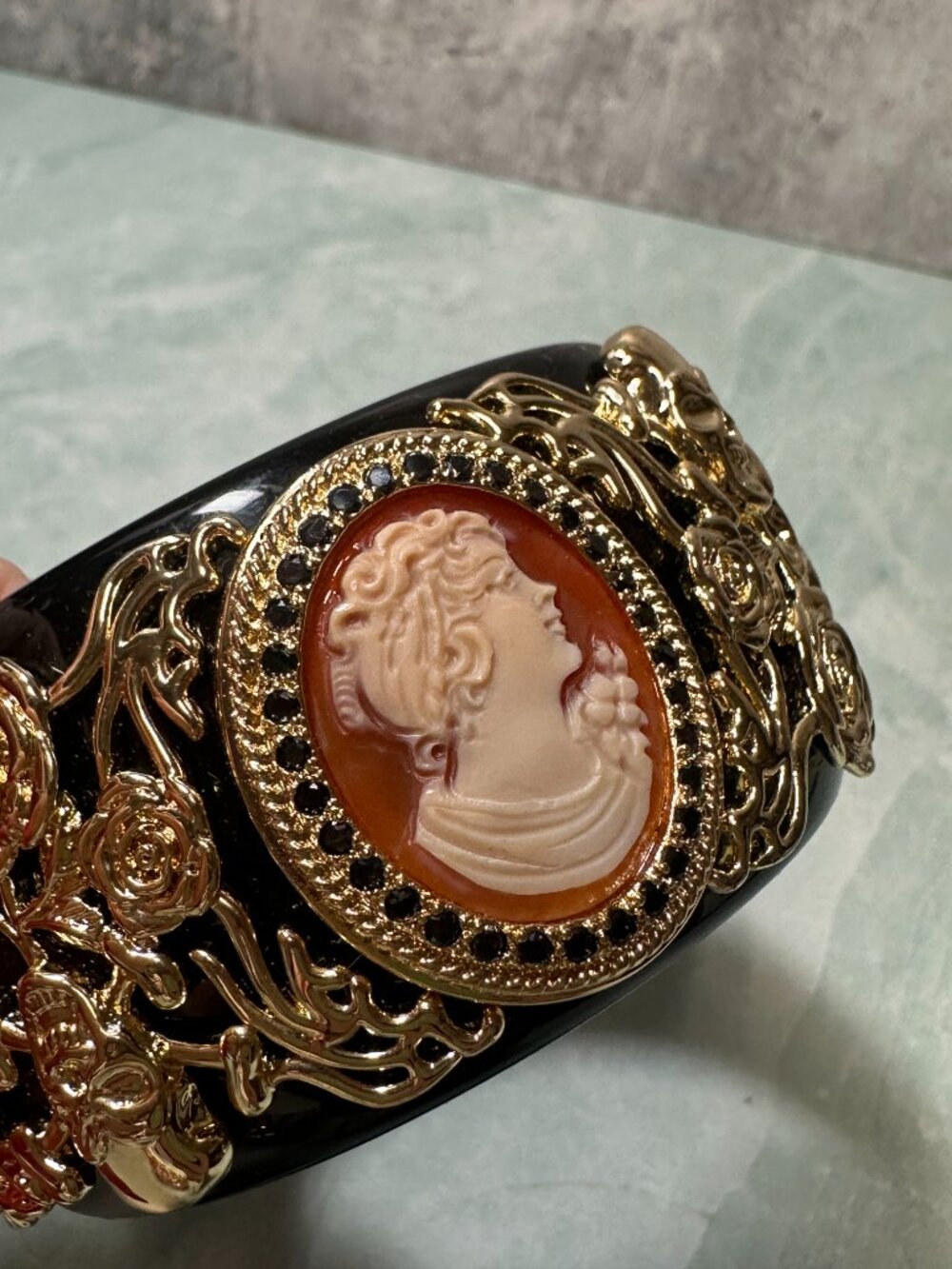 Amedeo NYC black lucite statement bangle bracelet featuring a hand carved cameo